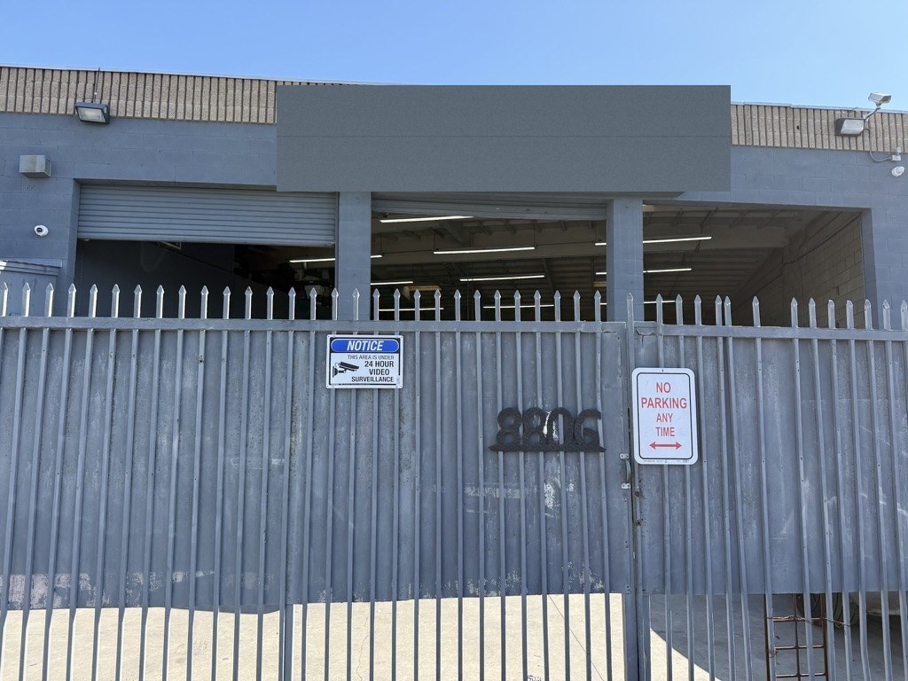 Close exterior photo of the Glamis Auto Body shop gate and bay