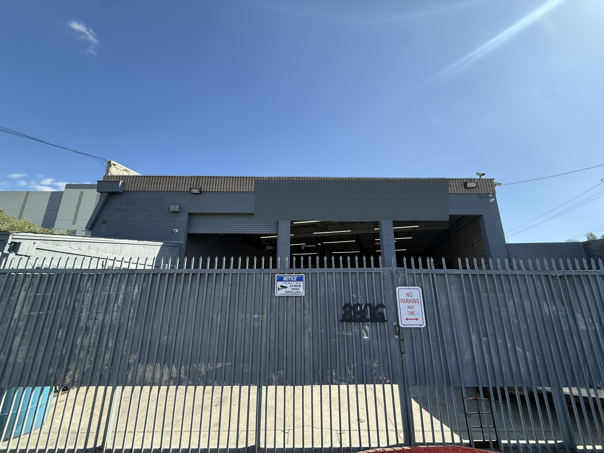 Wide exterior photo of the Glamis Auto Body shop frontage at 8806 Norwalk Blvd in Whittier